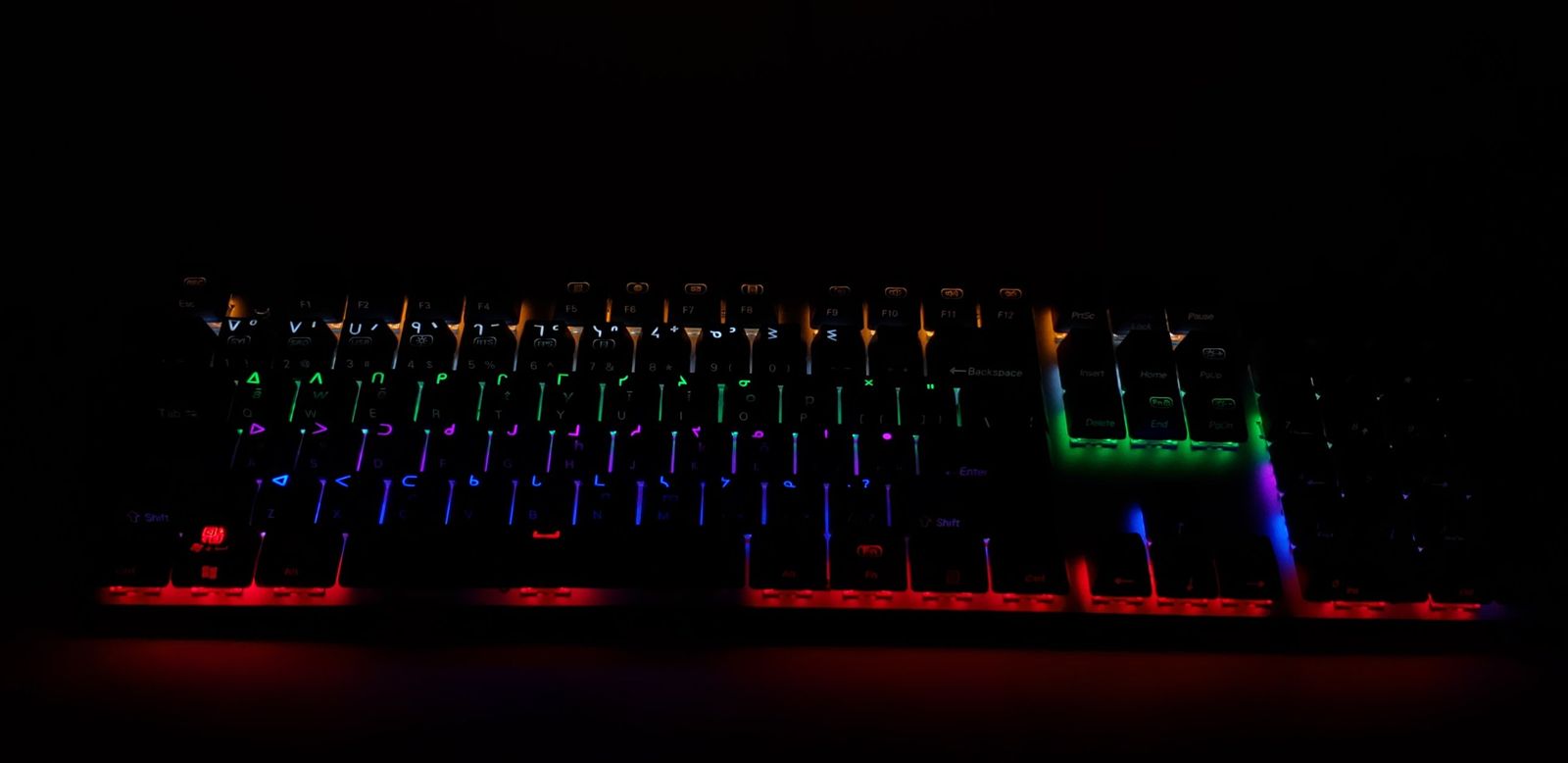 An FN Keys Plains Cree keyboard with syllabics on black backlit keys